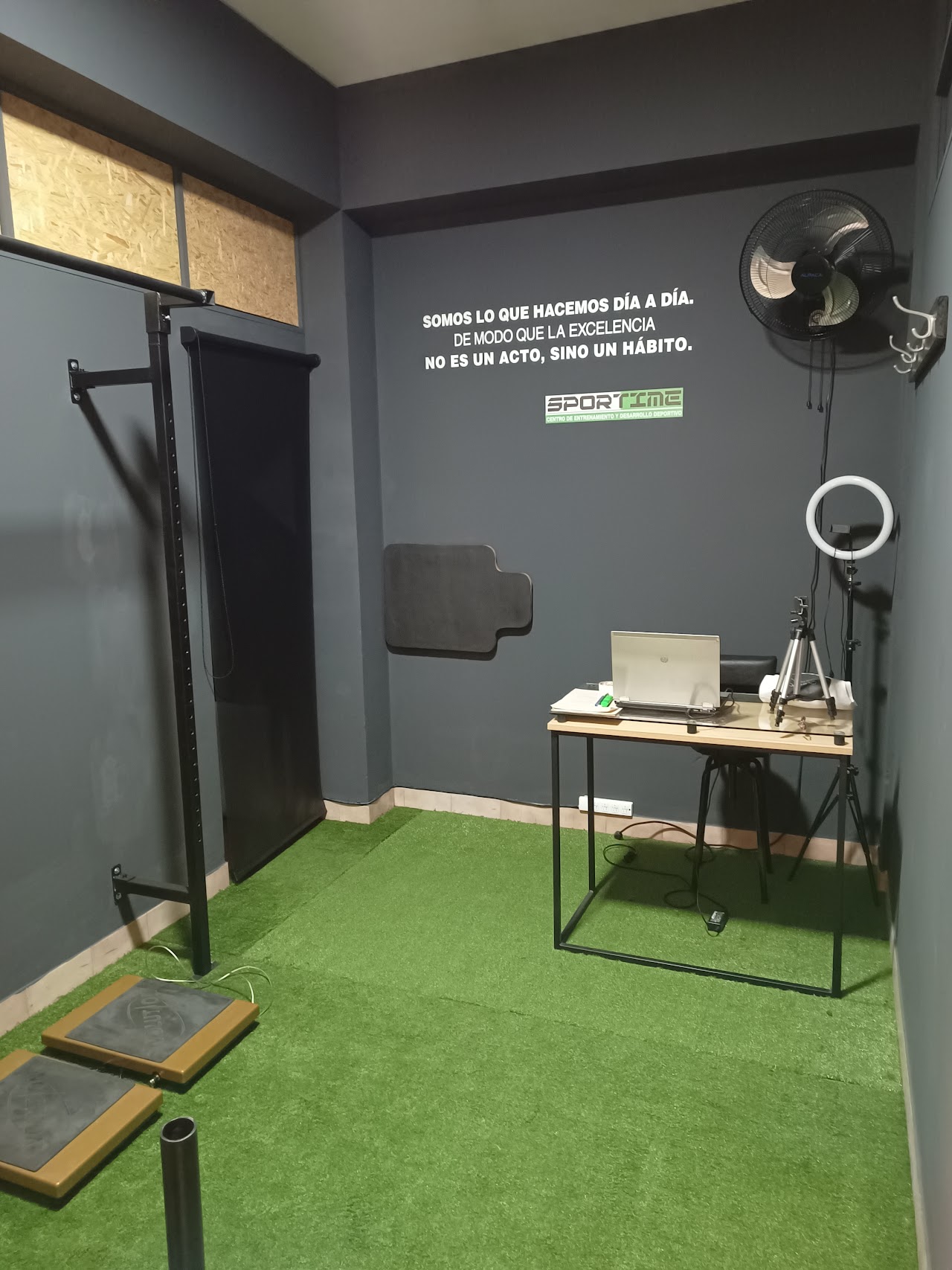 Stretching and mobility studio area with mats, foam rollers, wall bars, clean modern wellness athletic center, bright warm ambient lighting